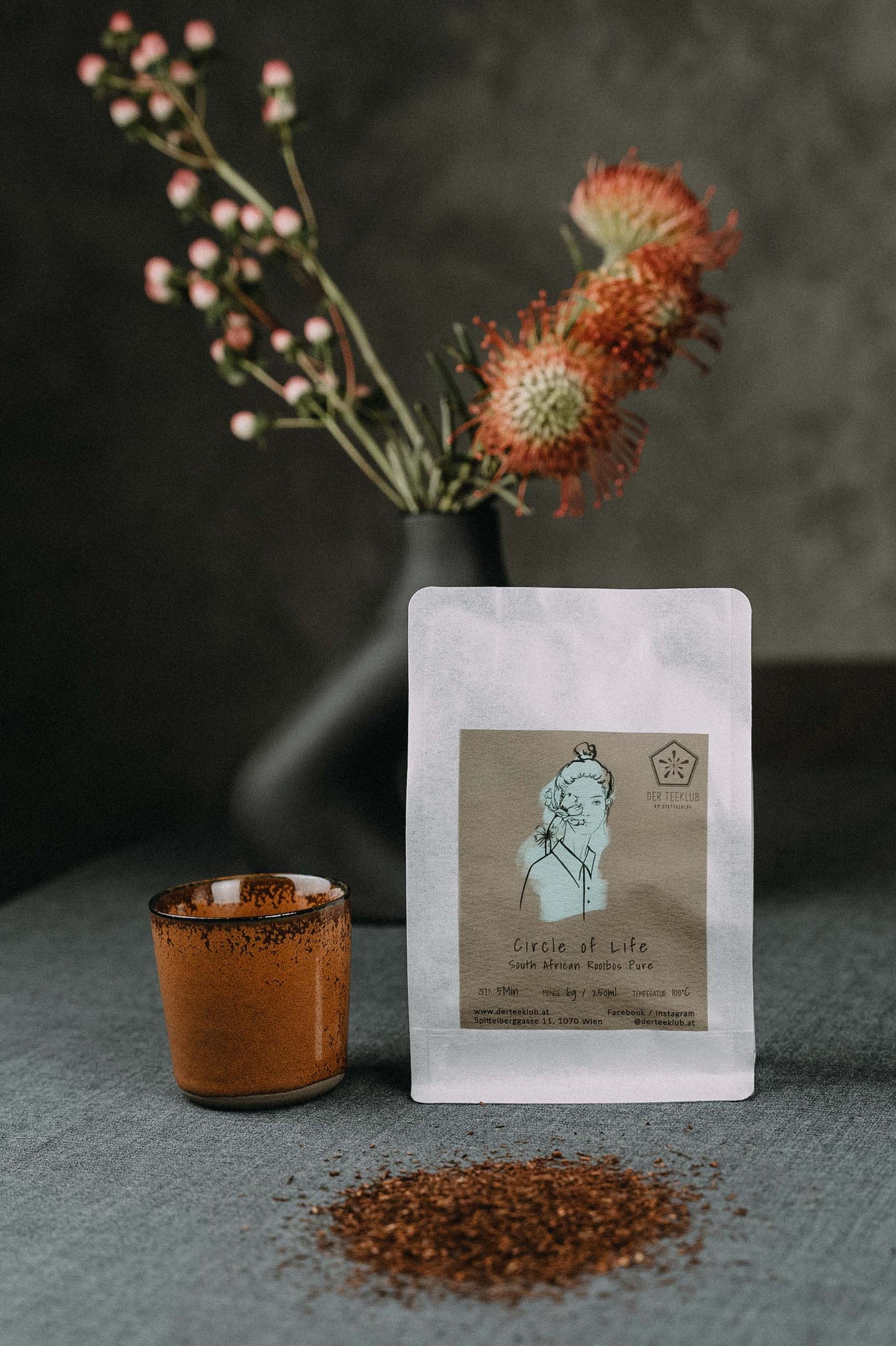 Südafrikanischer Rooibos gestreut auf Tisch mit roter Tasse